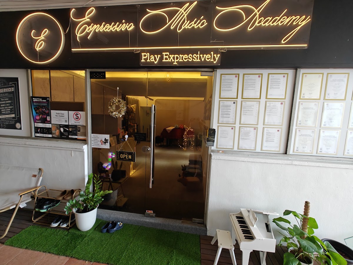 The Espressivo Music Academy shopfront: neon script sign, glass door, and a little white toy piano outside