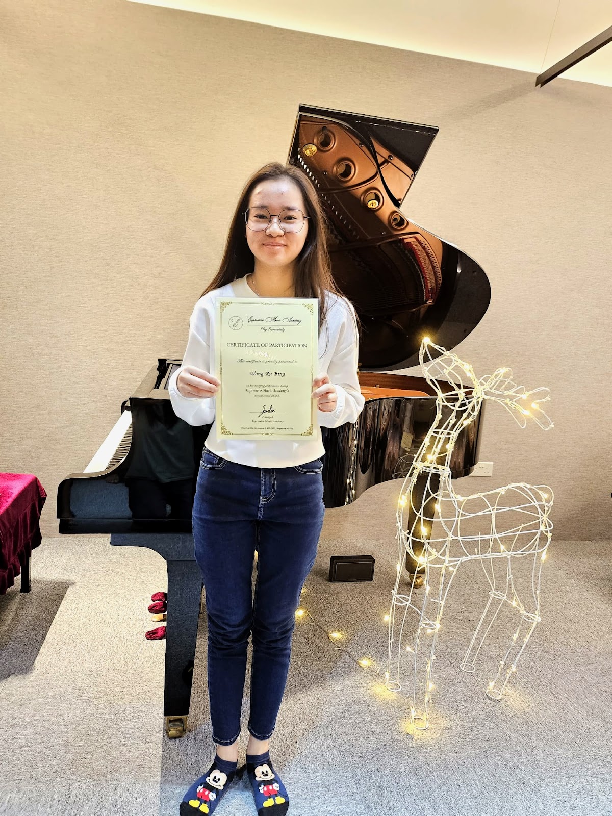 A student with her annual recital certificate