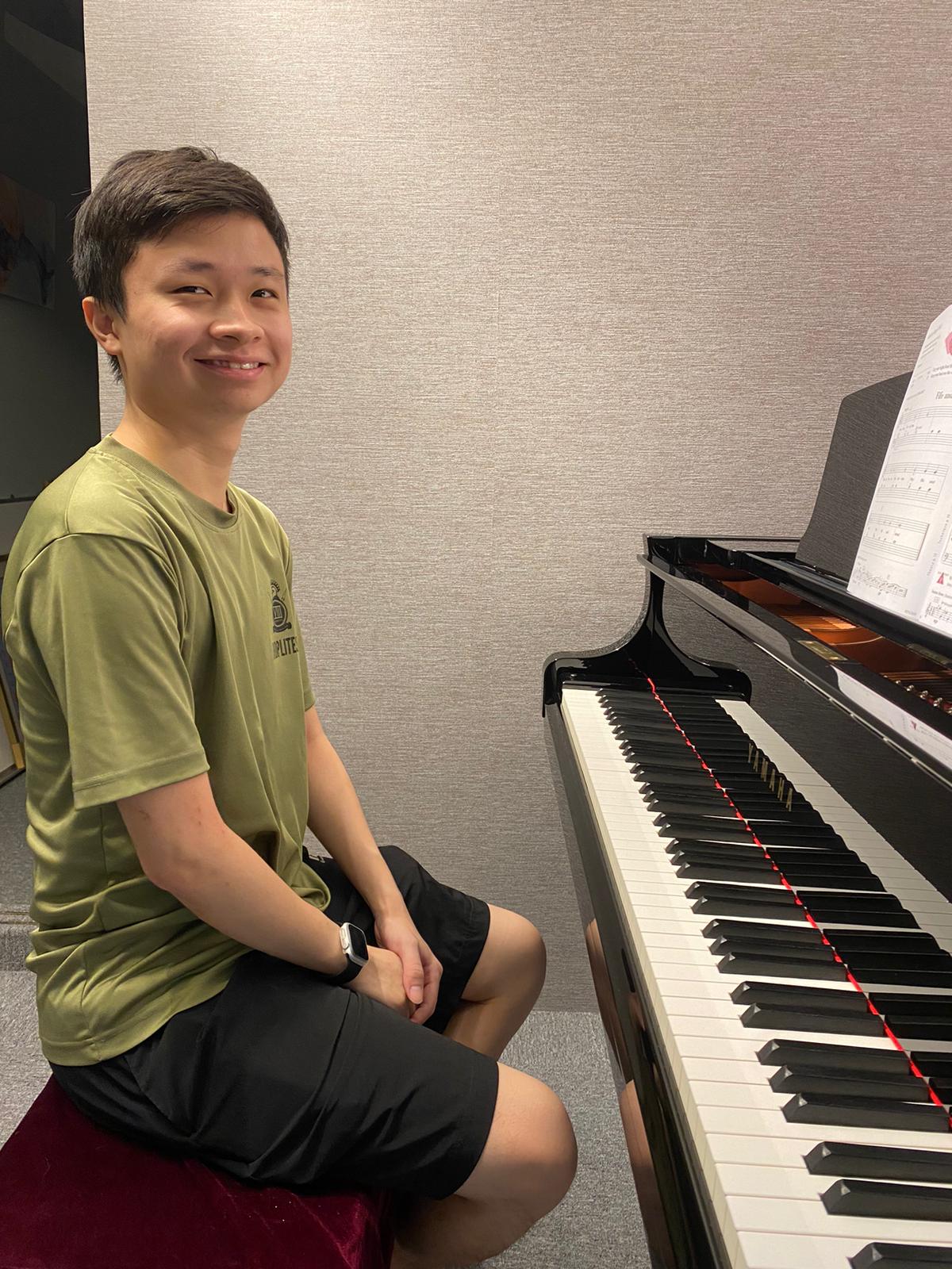 An older student at the keys, in a soundproofed room