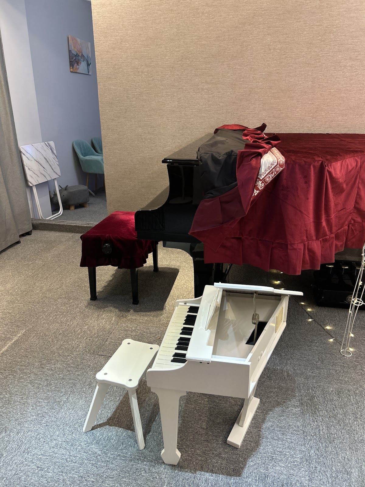 The covered grand and the little white toy piano