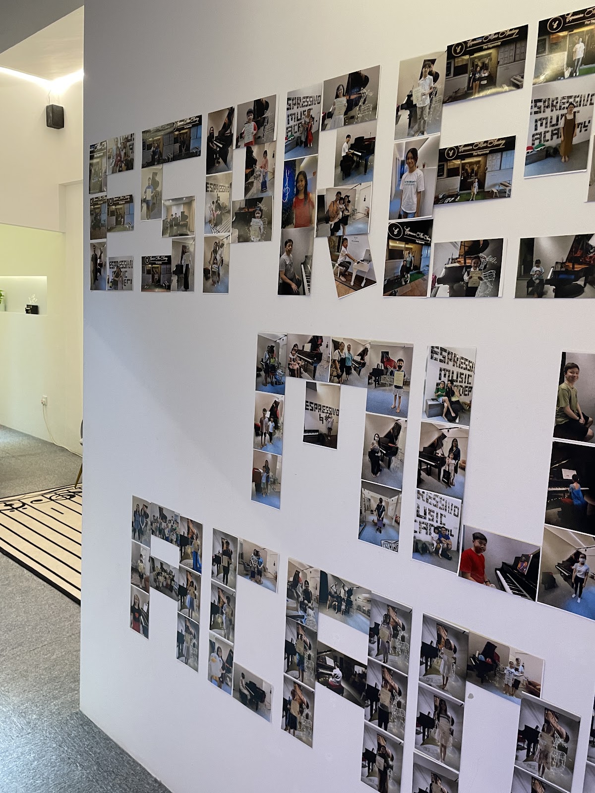 The photo wall: students spelling out the academy's name